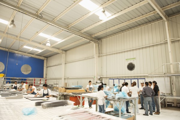 Workers talking in manufacturing plant