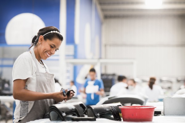 Worker smiling in manufacturing plant