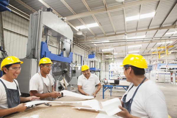 Workers talking in manufacturing plant