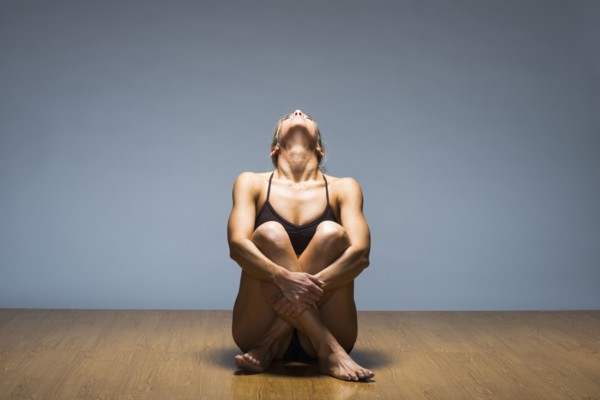Caucasian woman practicing yoga in studio