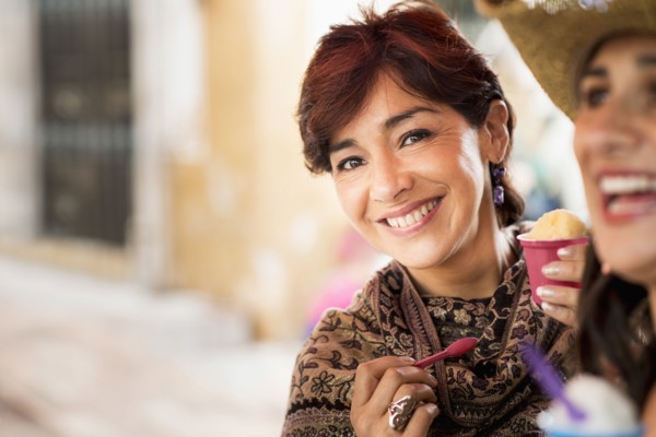 Hispanic woman eating ice cream