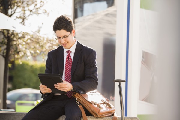 Hispanic businessman using tablet computer
