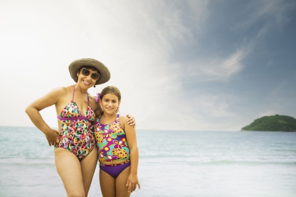 Mother and daughter smiling on beach