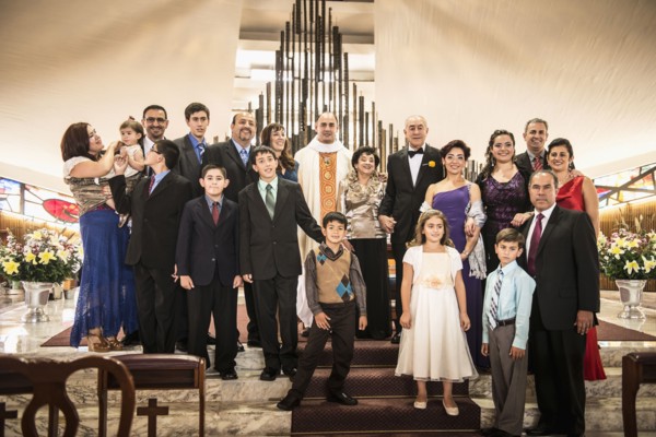 Family posing at wedding in church