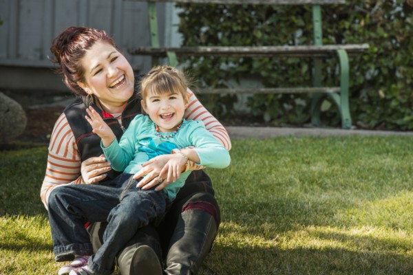 Mother and daughter smiling outdoors