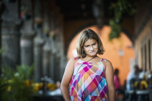 Hispanic girl making a face outdoors