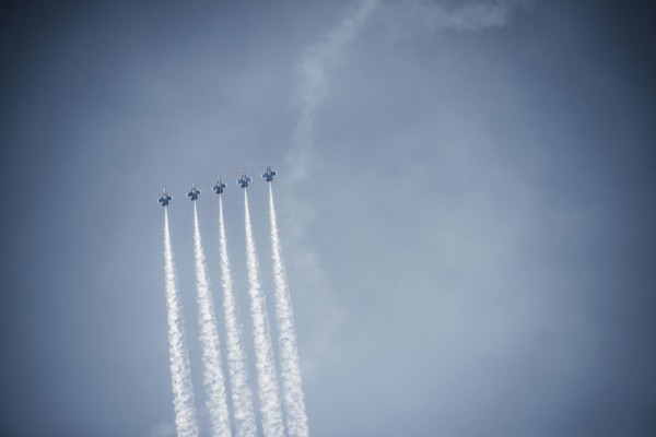 Jets flying in formation in cloudy blue sky