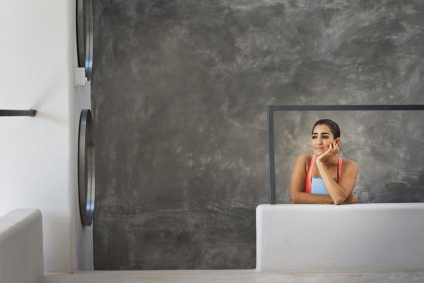 Hispanic woman sitting in modern living room