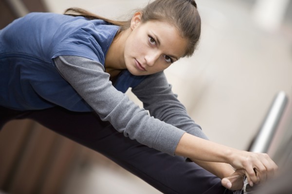 Hispanic woman stretching