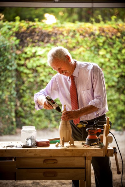 Man building birdhouse in garage