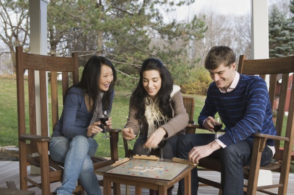 Friends playing scrabble on porch