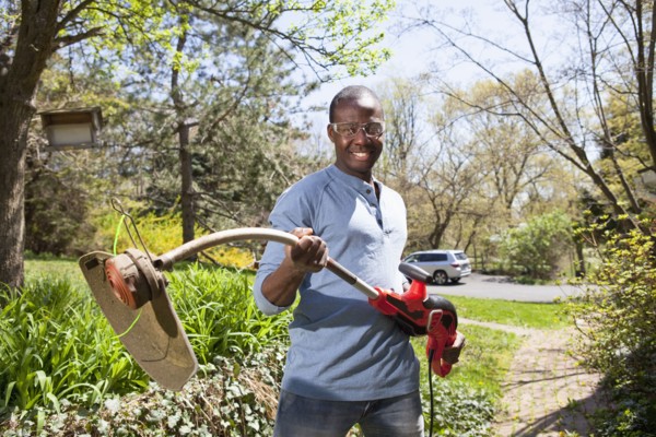 Black man holding weed trimmer