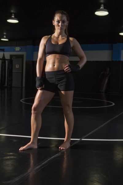 Caucasian fighter standing in gym
