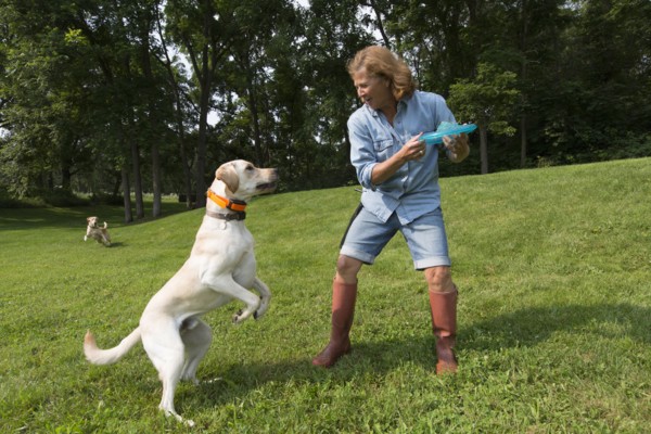 Caucasian woman playing with dog in park