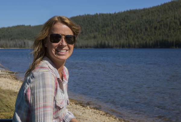 Caucasian woman sitting at remote lake