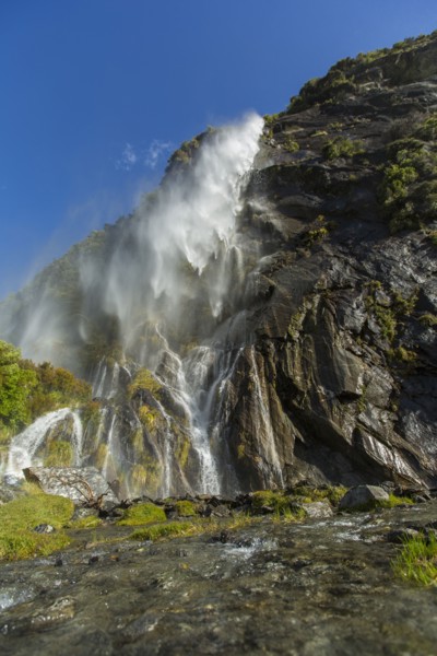 Waterfall pouring over remote cliff