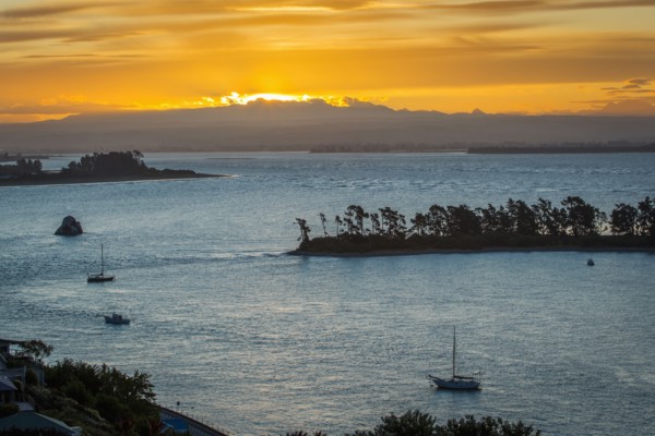 Aerial view of boats sailing near island sandbar