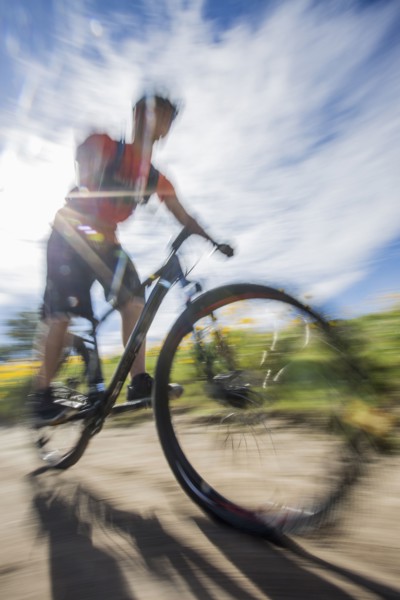 Blurred view of man riding mountain bike