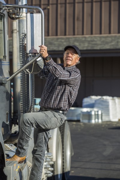 Caucasian man climbing into semi-truck