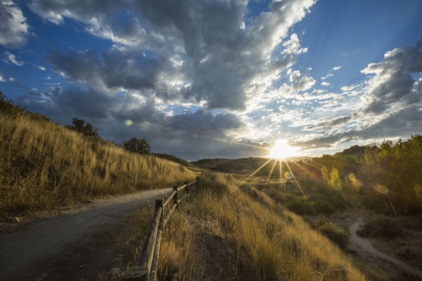 Sunset over distant mountain path