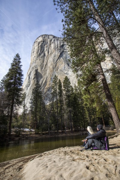 Caucasian couple sitting near river