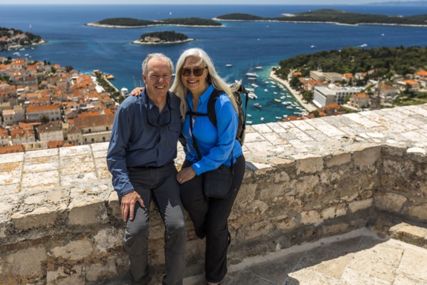 Caucasian couple posing near scenic view of ocean
