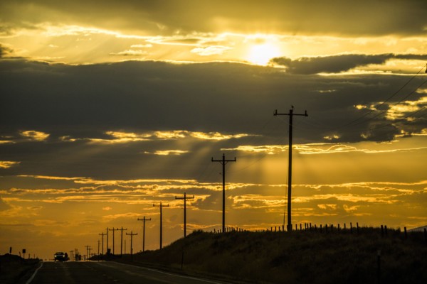 Road and utility poles at sunset