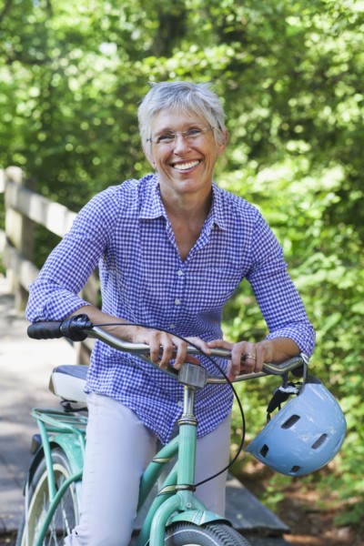 Portrait of Caucasian woman posing with bicycle