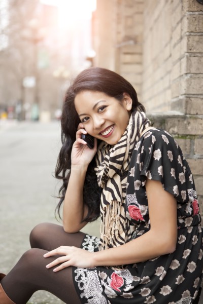 Mixed race woman talking on cell phone
