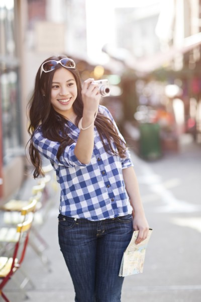Chinese woman taking pictures with digital camera