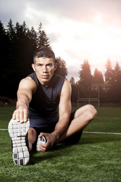 Hispanic man stretching before exercise