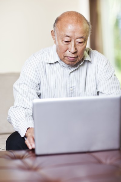 Chinese man using laptop
