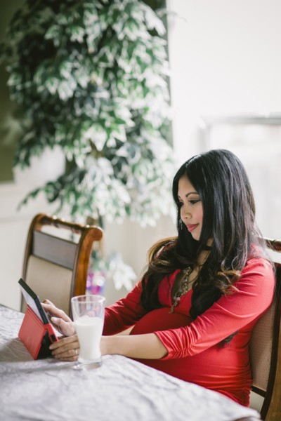Pregnant Asian woman using digital tablet