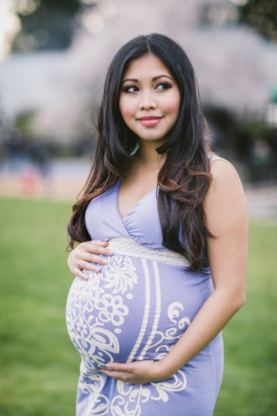 Asian woman holding her pregnant belly