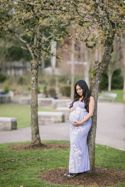 Asian woman holding her pregnant belly