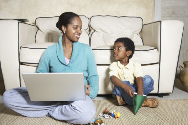African American mother sitting with son and laptop