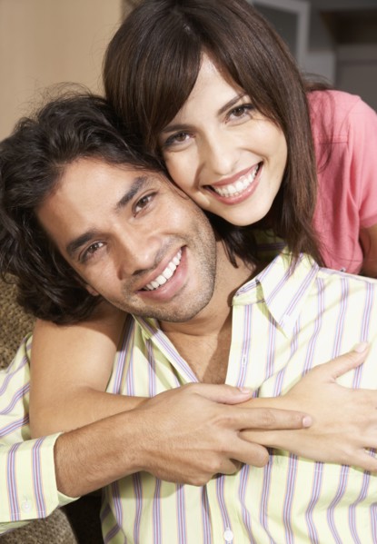 Close up of Hispanic couple hugging