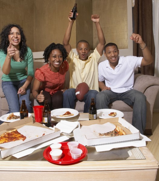 Multi-ethnic friends watching sports on television