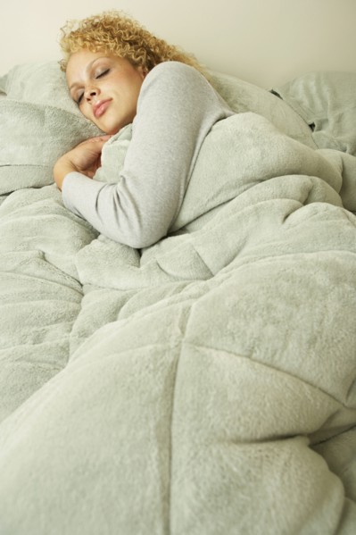 Young woman sleeping in bed
