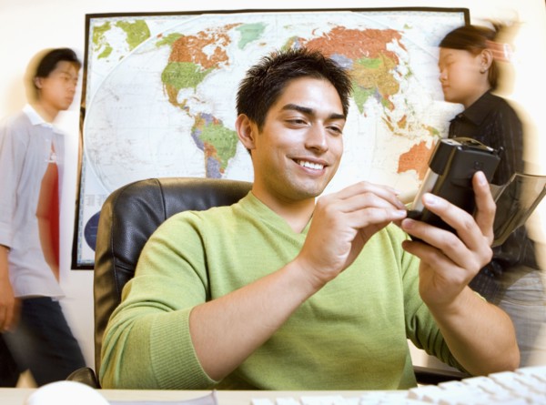 Pacific Islander businessman using electronic organizer