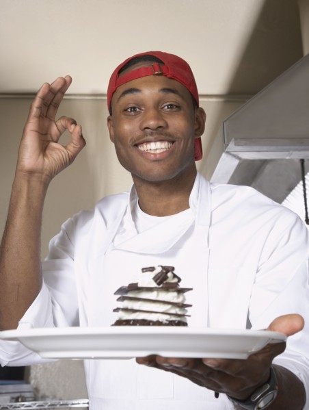 African American male chef holding desert
