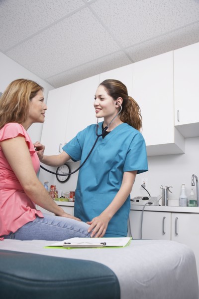 Hispanic female medical professional examining patient
