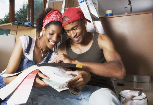 African American couple looking at paint swatches