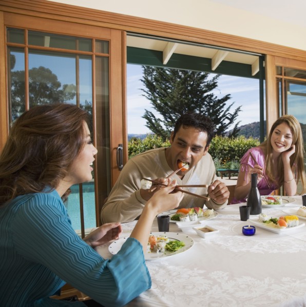 Multi-ethnic couples eating sushi