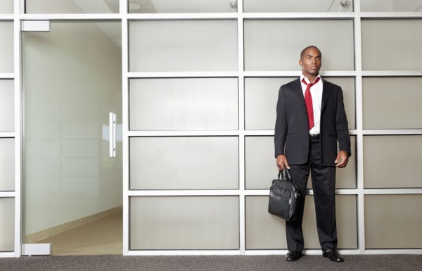 Mixed race businessman standing in modern office