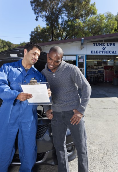 Mechanic explaining paperwork to customer