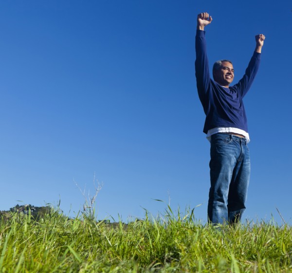 Hispanic man cheering outdoors