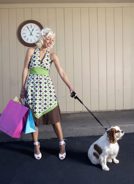 Caucasian woman with dog on sidewalk