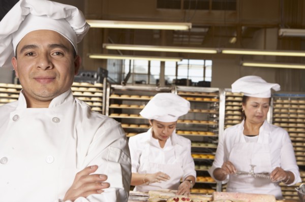 Hispanic bakers working in bakery