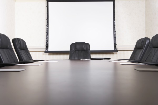 Empty chairs at conference table